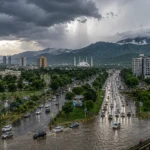 Dark monsoon clouds gather over a Pakistani city as heavy rainfall raises the risk of urban flooding.